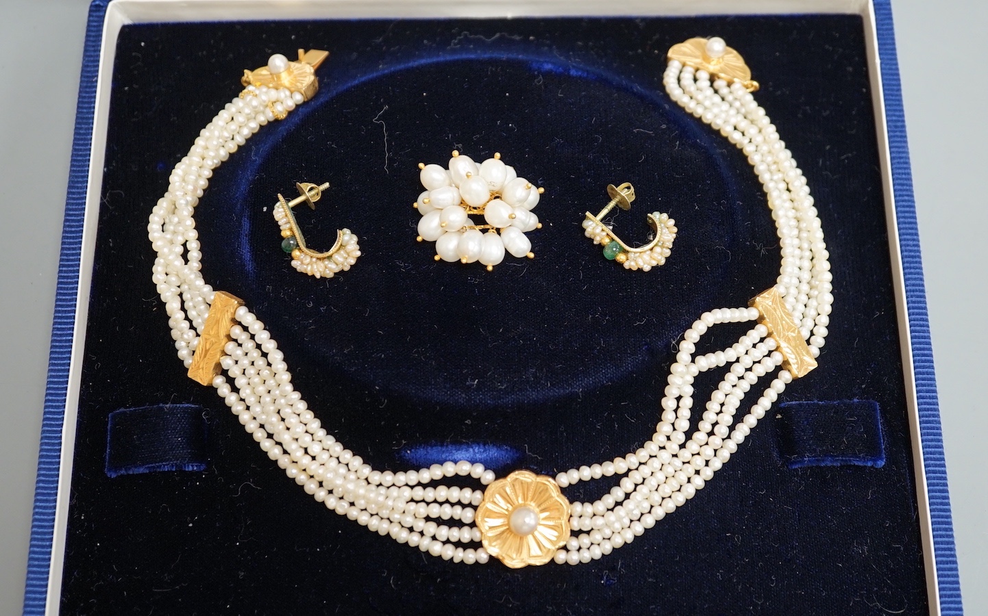 A modern cased Middle Eastern yellow metal and quintuple strand necklace, 36cm, a similar yellow metal and cultured pearl cluster ring and a pair of earrings.